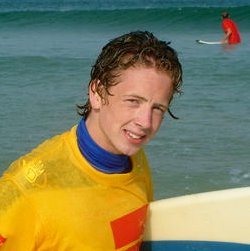 Aaron surfing in wet T-shirt